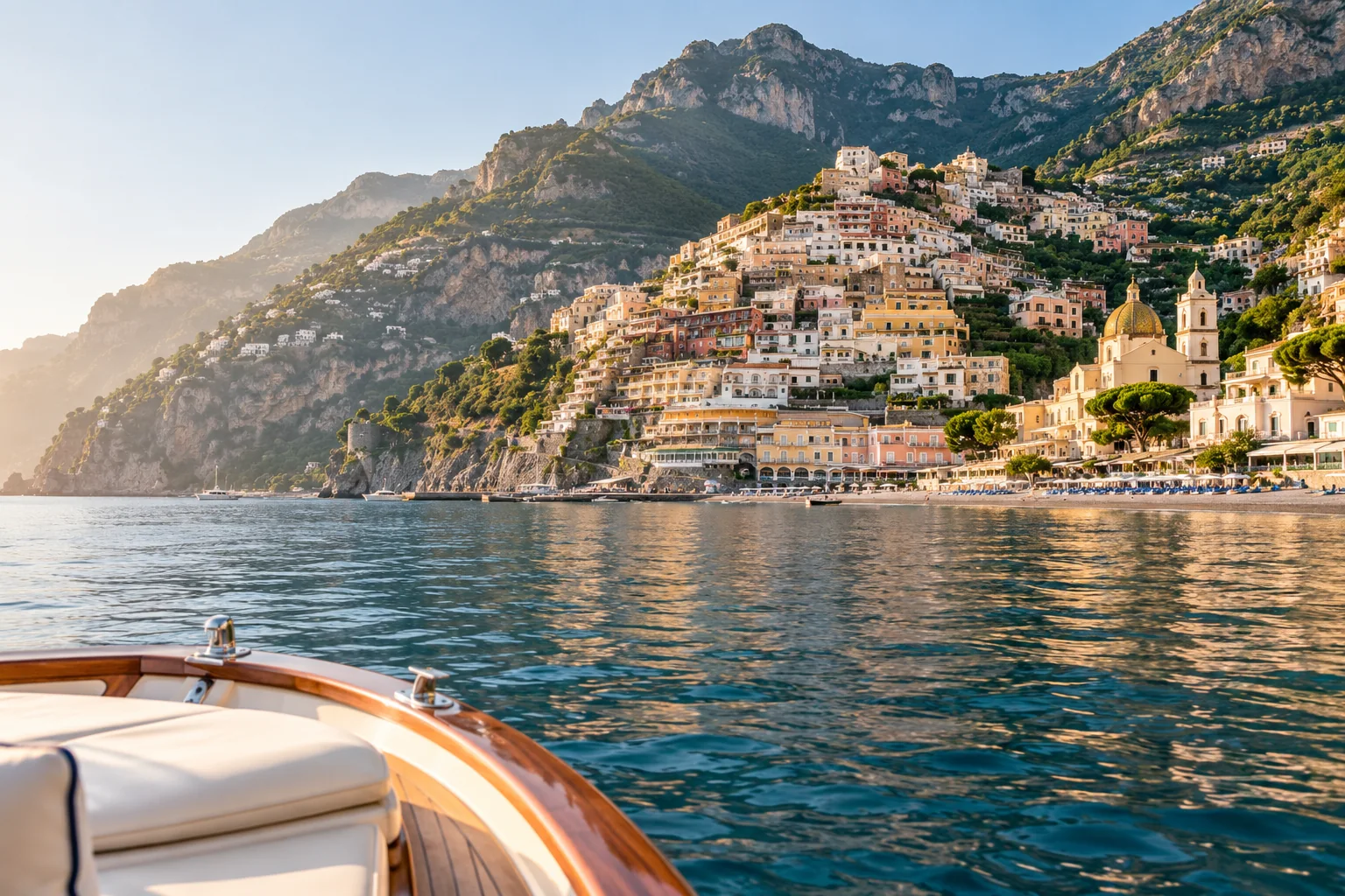 A private boat approaching the Amalfi Coast at golden hour.